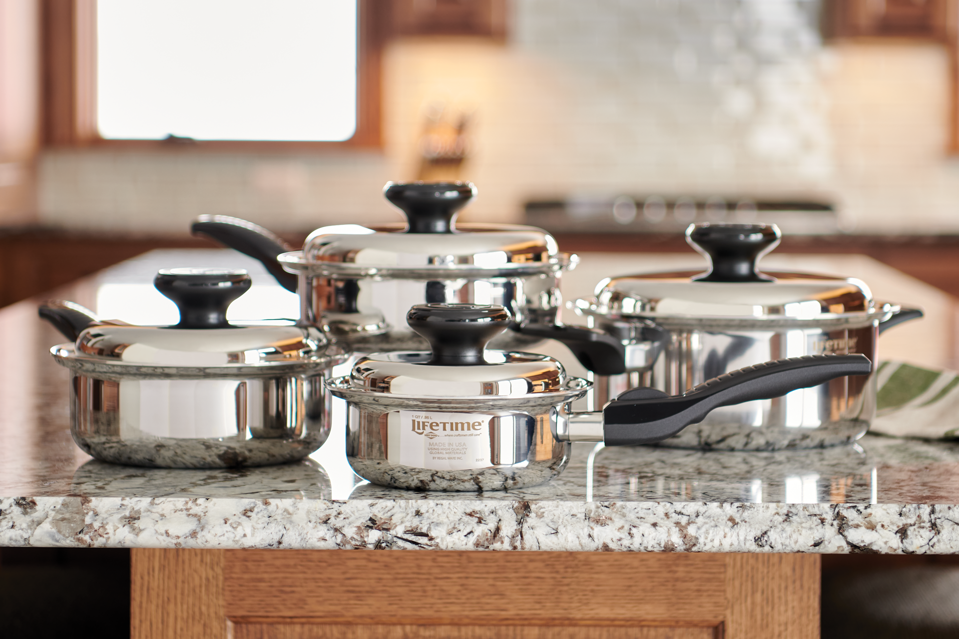 Four Lifetime Cookware Pots on a Granite Countertop