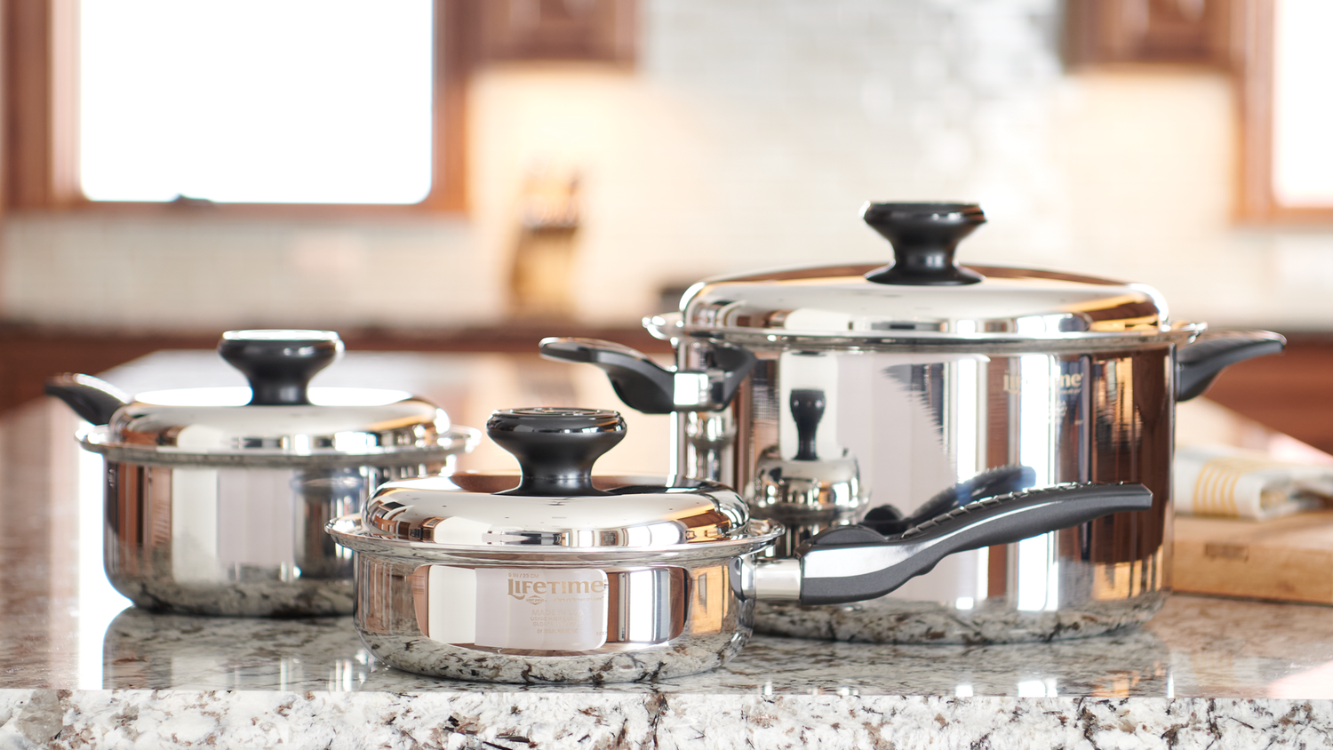 Three Lifetime Cookware Pots on a Granite Countertop